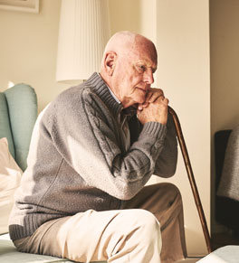 older man with cane in pain