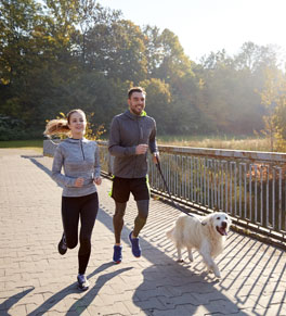 couple and dog exercising together