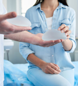 woman looking at breast implants at doctor's office