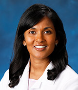 Dr. Lilangi Ediriwickrema, pictured in her lab coat, is a board-certified UCI Health ophthalmologist who specializes in ophthalmic plastic and reconstructive surgery, neuro-ophthalmology and orbital disease.
