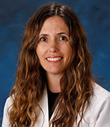Dr. Felicia Lane, pictured in her physician's white coat, is a board-certified UCI Health gynecologist who specializes in urogynecology and female pelvic reconstructive surgery.