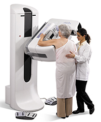 Woman prepares for mammography on Selenia® Dimensions® 3-D system.