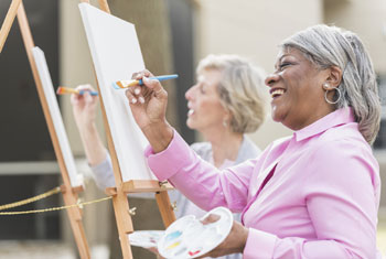 two women painting on easels