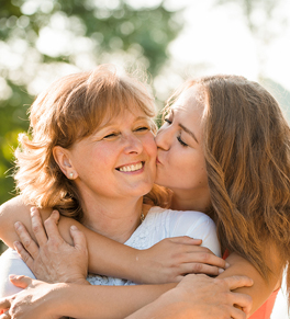 gynecologic cancer survival; mother, daughter hugging and smiling