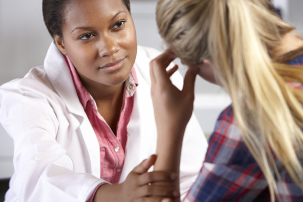 woman with headache visiting doctor for allergies