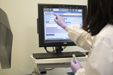 woman checking blood test lab results on computer 