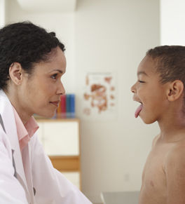 doctor checking young boy