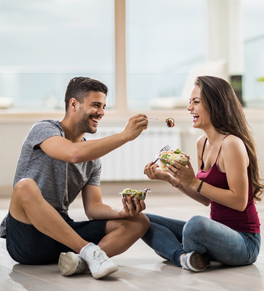 man and woman eating food