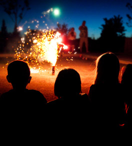 people gathered around lighted fireworks