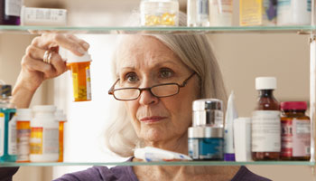 woman looking at medications