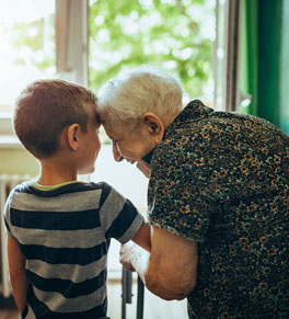 frail elderly woman with young boy