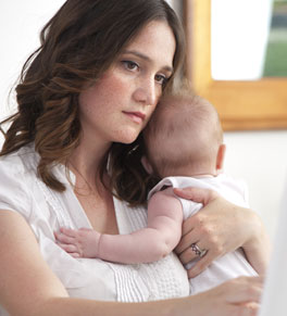 woman with postpartum depression holding baby