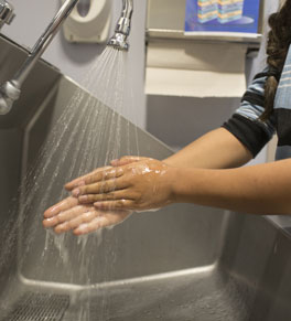 person washing hands at hospital