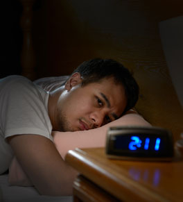 man lying awake in the middle of the night