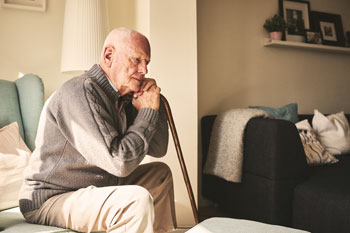 older man resting with cane