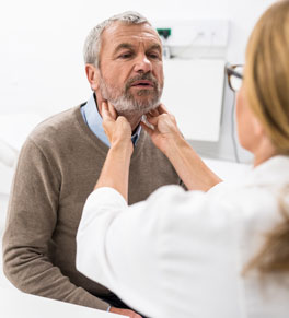 man being examined by doctor for throat cancer
