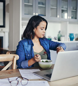woman doing intermittent fasting checking her watch, getting ready to eat