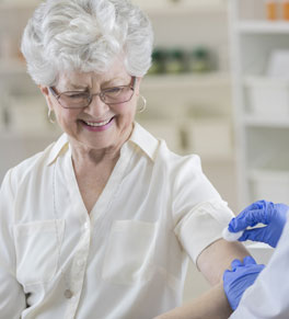 senior woman getting flu shot