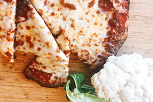 A cauliflower crust lightens up the calorie count of pizza but not the flavor.