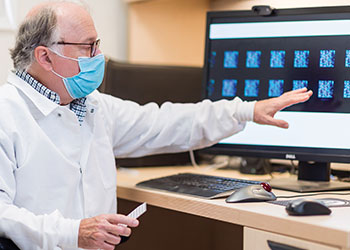 UCI virology expert Philip Felgner, PhD, shows the blood samples his team is studying to determine which have antibodies to COVID-19.