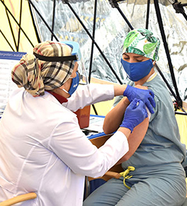 Respiratory therapist Vita Susin is the first frontline UCI Health caregiver to receives a COVID-19 vaccination.
