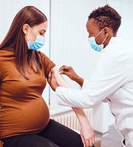 Pregnant woman gets vaccinated.