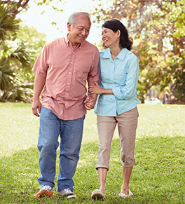 Asian couple strolling through a park