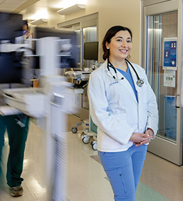 UCI School of Medicine student Violeta Osegueda stands amid the bustle of the critical care intensive care unit at UCI Douglas Hospital, where she trained during the height of the COVID-19 surge in January 2021.