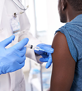Doctor gives patient a vaccine injection
