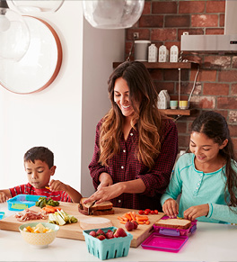 Latina mom prepares healthy food with daughter and son in the kitchen.