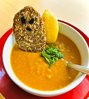 Dress up this savory pumpkin-lentil soup with ghostly seed crackers for Halloween.