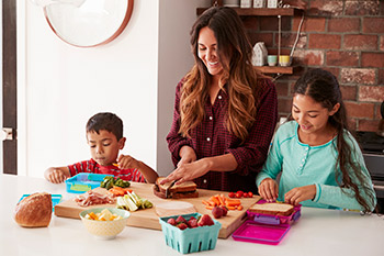 Mother teaches her kids how to pack a healthy lunch to build their immune systems.
