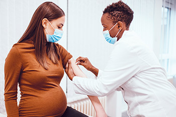 Pregnant woman gets a COVID-19 vaccination.