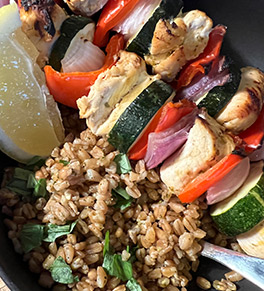 Colorful Sicilian chicken and vegetables skewers with farro pesto.