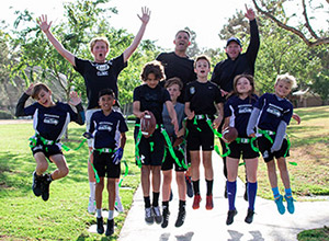 Former NFO linebacker Vince Bruno's flag football team, the Seahawks, cheers after a successful practice.