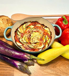 Roasted garlic ratatouille in turquoise baking dish.