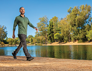 UCI Health IBD patient David Webster walks the trail around Laguna Lake in Fullerton.