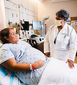 High-risk UCI Health maternity specialist Dr. Carol Major reassures Litiola Foloifo, who was facing premature delivery.