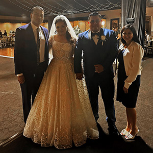 Xenia Morales and her new husband, Fernando Guerrero, are flanked at their wedding reception by Dr. Uttam Reddy, left, and his wife, Dr. Radhika Reddy, at right.