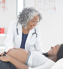 Expectant Black mother talks with her Black physician.