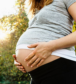 Pregnant woman holding her belly