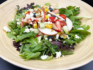 Summer farro salad served on a beige platter.