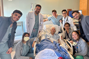 transcatheter valve replacement TAVR patient Joe bush in his hospital bed at UCI medical center surrounded by his care team