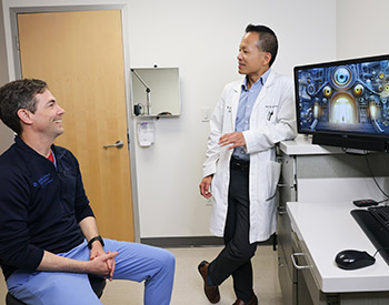 UCI Health ophthalmologists Dr. Andrew Browne, left, and Dr. Dr. Ken Lin chat about their efforts to develop tools to improve patient care with the aid of artificial intelligence.