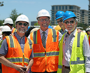 left to right, UCI Health President and CEO Chad Lefteris, UCI medical school Dean Michael Stamos, cancer center director Dr. Richard Van Etteon and chief information officer Scott Joslyn at a July 2023 ceremony at the UCI Health — Irvine consruction site.