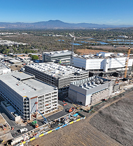 Aerial view of UCI Health — Irvine under construction with the all-electric power plant in the foreground at right.