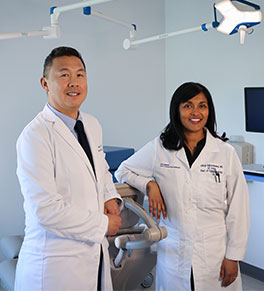 Dr. Jeremiah Tao and Dr. Lilangi Ediriwickrema stand together in an exam room.