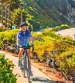 Avid cyclist Linda Kiel, riding her bike at Salt Creek Beach near Dana Point, is living life to the fullest, her cancer in remission from immunotherapy.