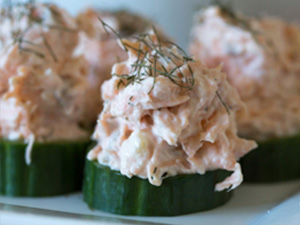Salmon spread is served on cucumber slices.