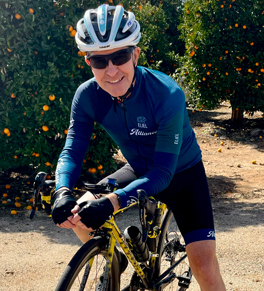 uci health cardiac rehab patient blaine bowman on his bike wearing a helmet